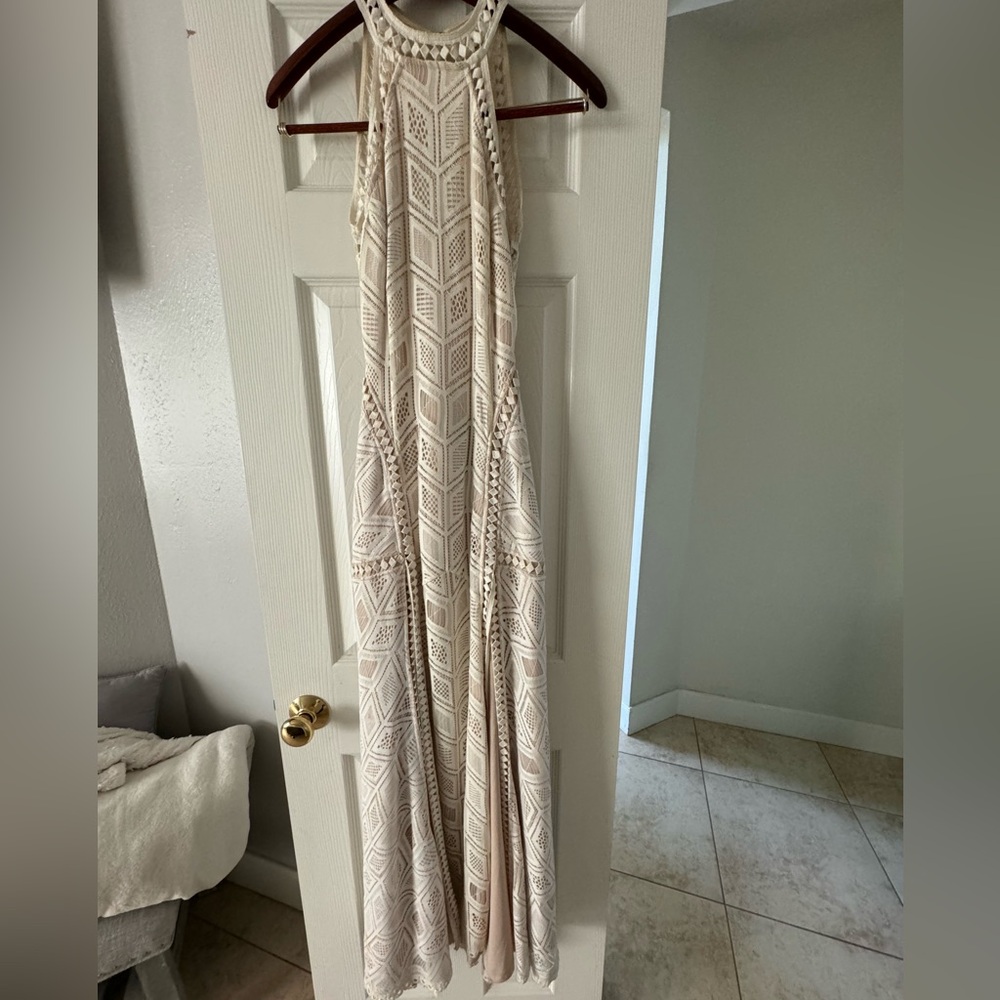 Beautiful cream color dress with 2 front slips and open low back.
